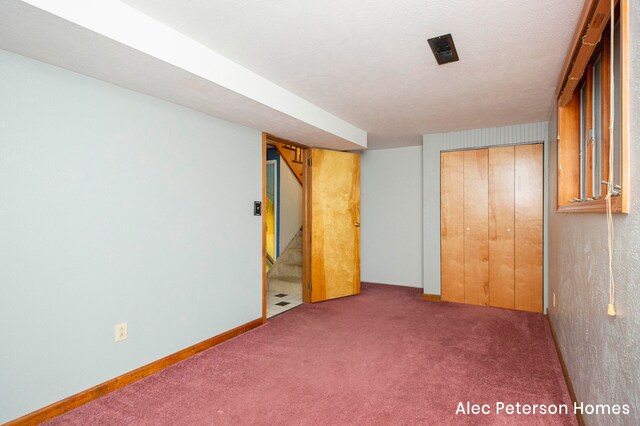 interior space with a closet and dark colored carpet