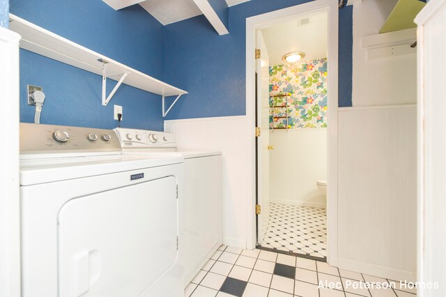 laundry area with light tile patterned flooring and independent washer and dryer