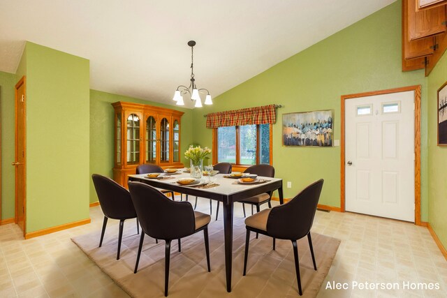 dining space featuring vaulted ceiling and a notable chandelier