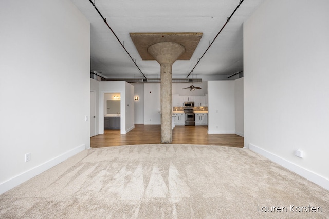 unfurnished living room with carpet floors and ceiling fan