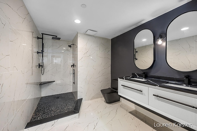 bathroom with a tile shower, vanity, and toilet