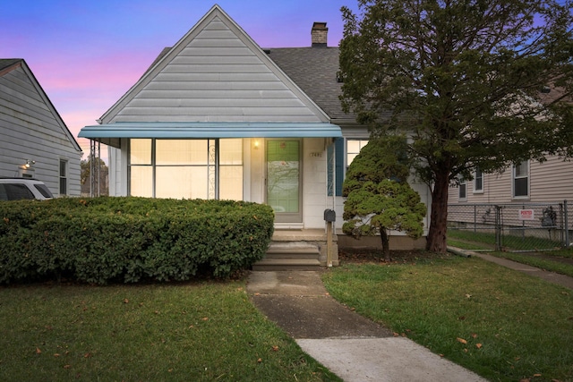 bungalow-style house with a porch and a yard