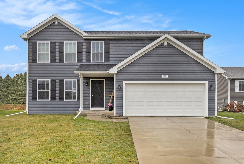 view of front of home featuring a garage and a front lawn