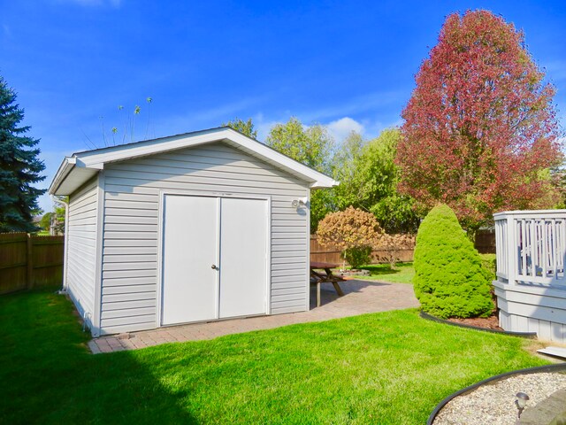 view of outbuilding featuring a lawn