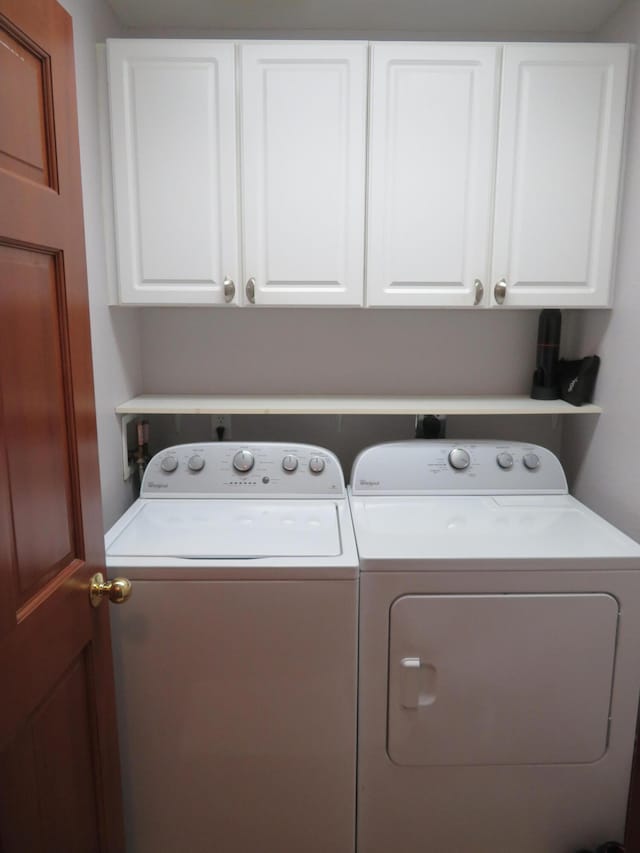 laundry area featuring cabinets and washing machine and clothes dryer