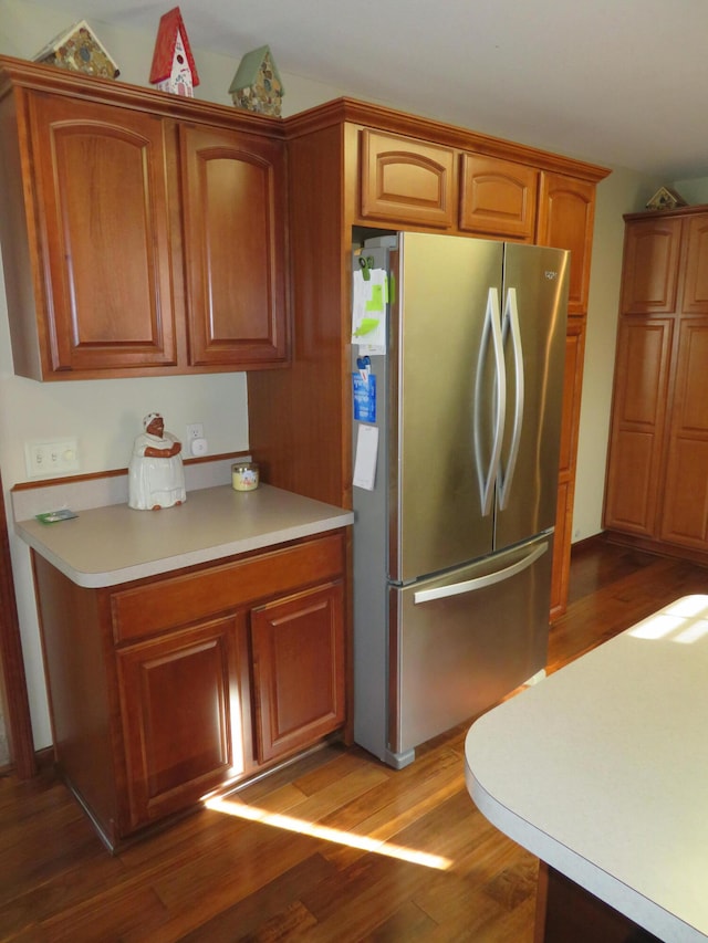 kitchen featuring stainless steel refrigerator and dark wood-type flooring