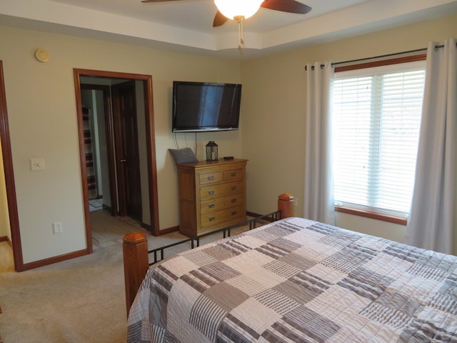 carpeted bedroom with ceiling fan, a walk in closet, and a closet