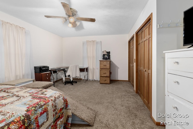 carpeted bedroom with ceiling fan and a closet