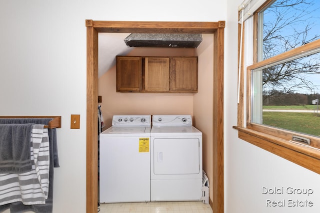 laundry area with cabinets and washing machine and dryer