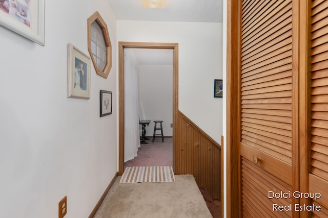 corridor featuring light colored carpet