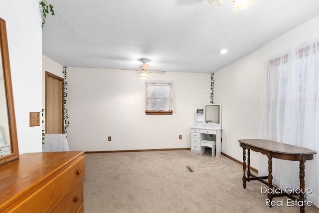 misc room featuring light carpet and ceiling fan