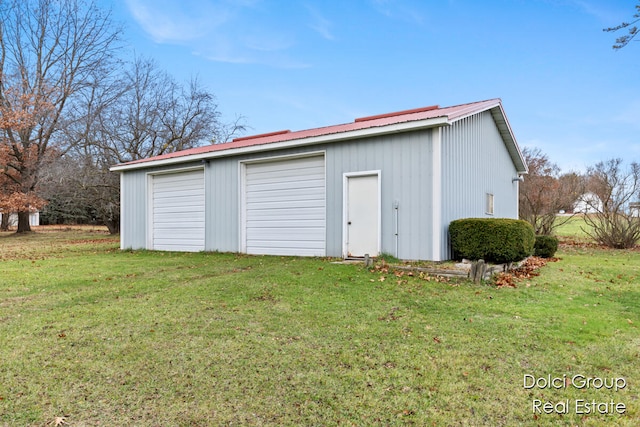 garage featuring a lawn