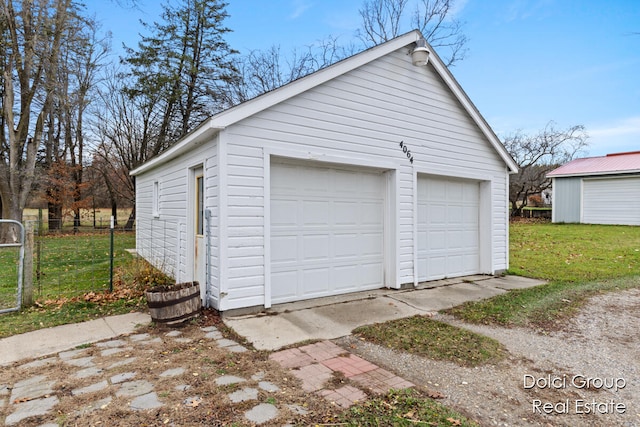 garage featuring a lawn