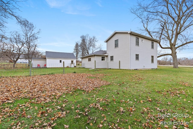 rear view of house featuring a lawn