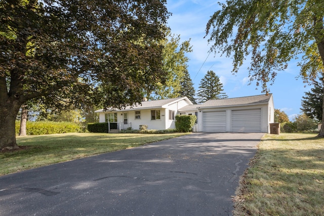 ranch-style house featuring a front yard and a garage