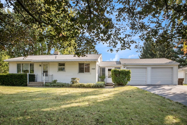 single story home featuring a garage and a front lawn