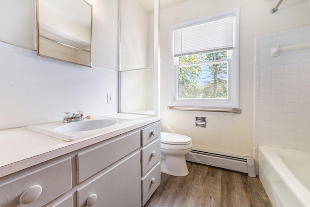 full bathroom featuring hardwood / wood-style floors, vanity, shower / washtub combination, toilet, and baseboard heating