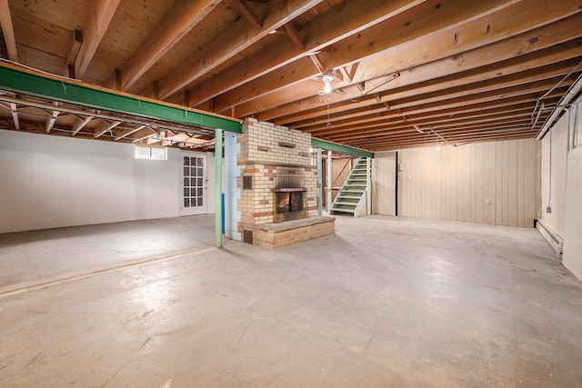 basement with a fireplace and a baseboard radiator