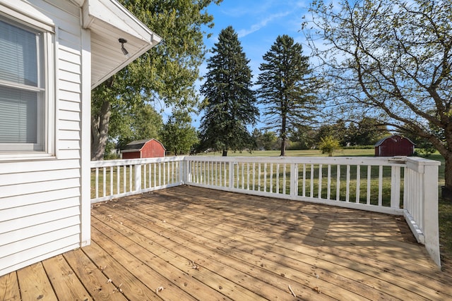 wooden deck featuring a storage unit