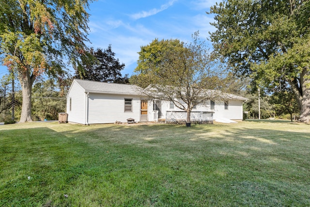 exterior space with a wooden deck and a front lawn