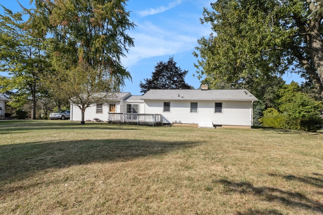 back of house featuring a wooden deck and a yard