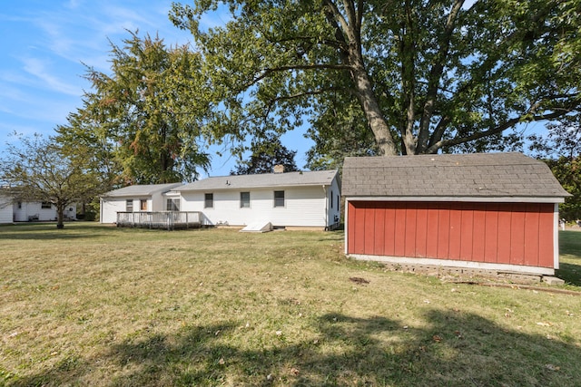 back of property with a yard, a storage shed, and a wooden deck