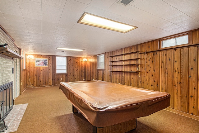 game room featuring a fireplace, wooden walls, and pool table