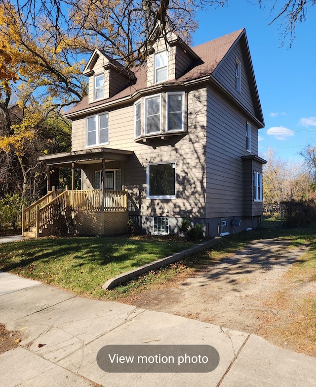 view of front of home featuring a front yard and a porch