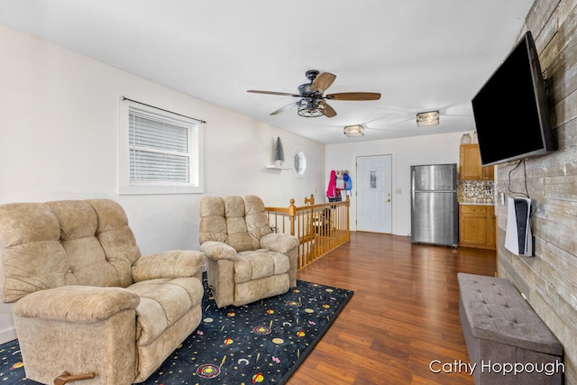 living room with ceiling fan and dark hardwood / wood-style floors