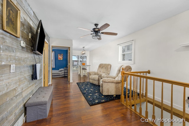 living room featuring ceiling fan and dark hardwood / wood-style flooring