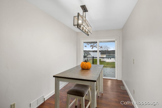 dining space with dark hardwood / wood-style floors