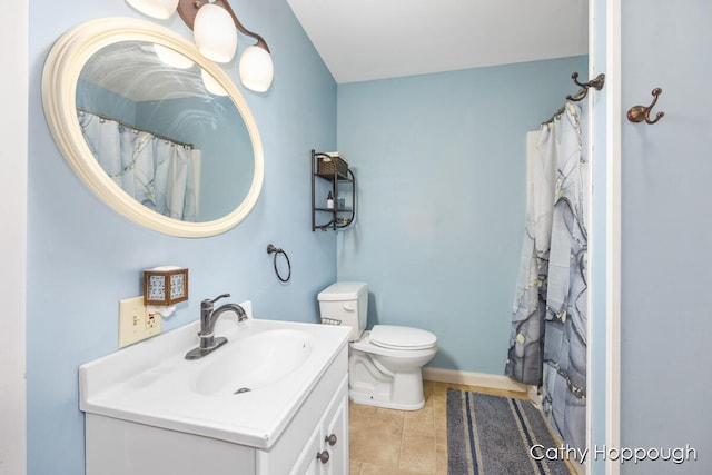 bathroom with tile patterned flooring, vanity, and toilet