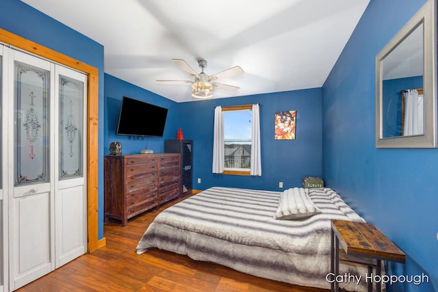 bedroom with ceiling fan and dark hardwood / wood-style flooring