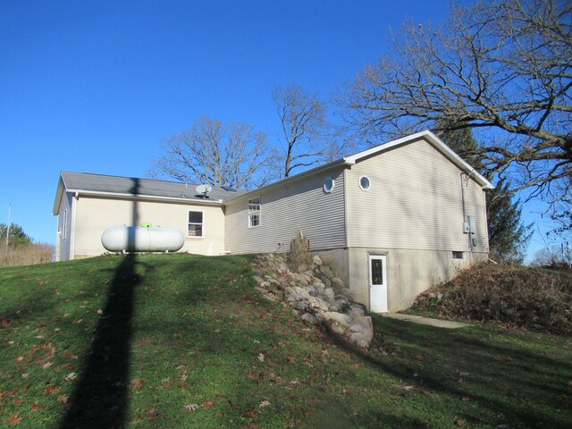 view of side of property with a yard