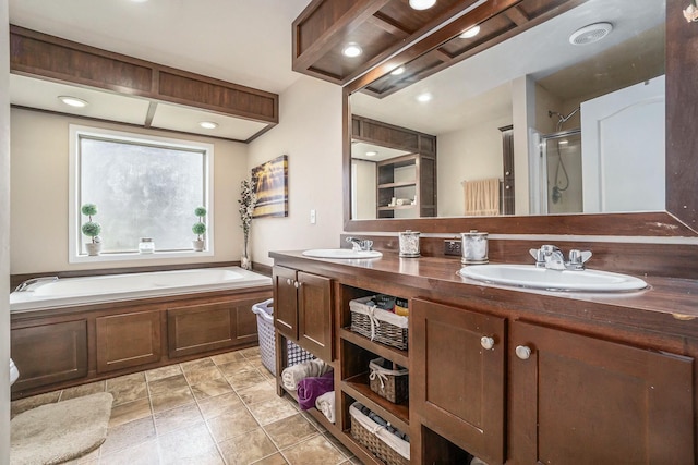 bathroom with tile patterned flooring, vanity, and shower with separate bathtub