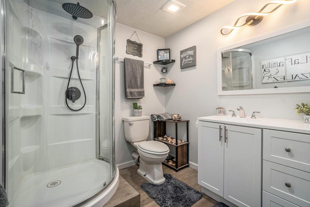 bathroom featuring hardwood / wood-style floors, toilet, an enclosed shower, and a textured ceiling