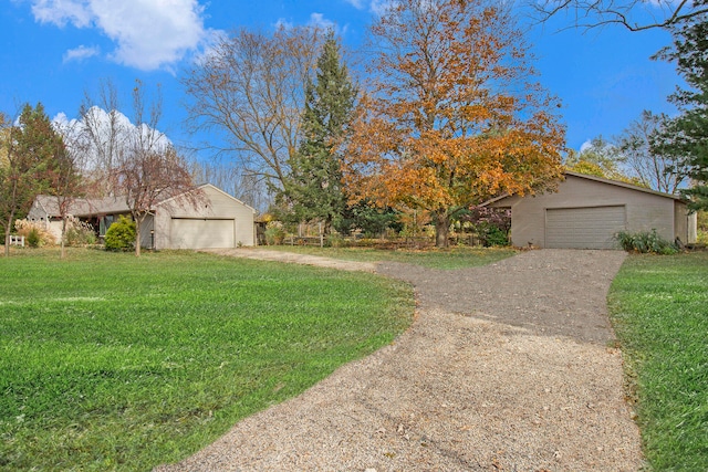 exterior space featuring a garage, an outdoor structure, and a front yard