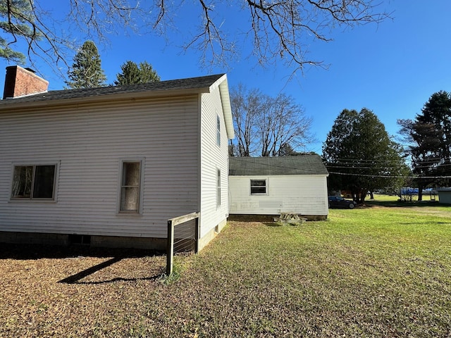 view of side of property with a lawn