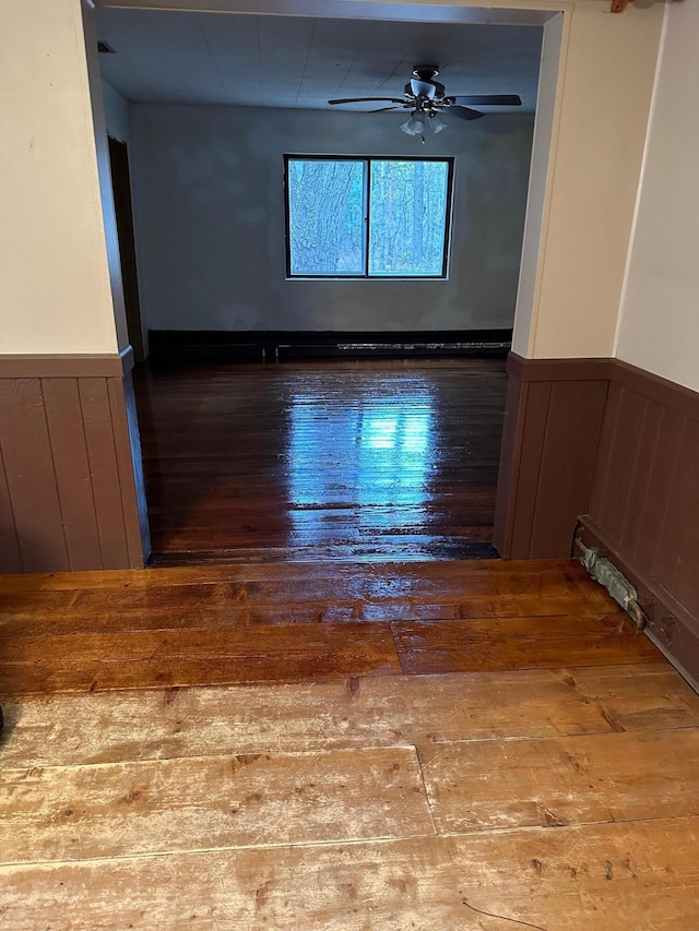 unfurnished room with hardwood / wood-style floors and ceiling fan