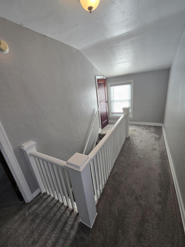 stairs featuring carpet flooring and lofted ceiling