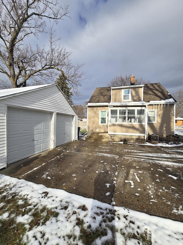 view of front of property featuring a garage and an outbuilding