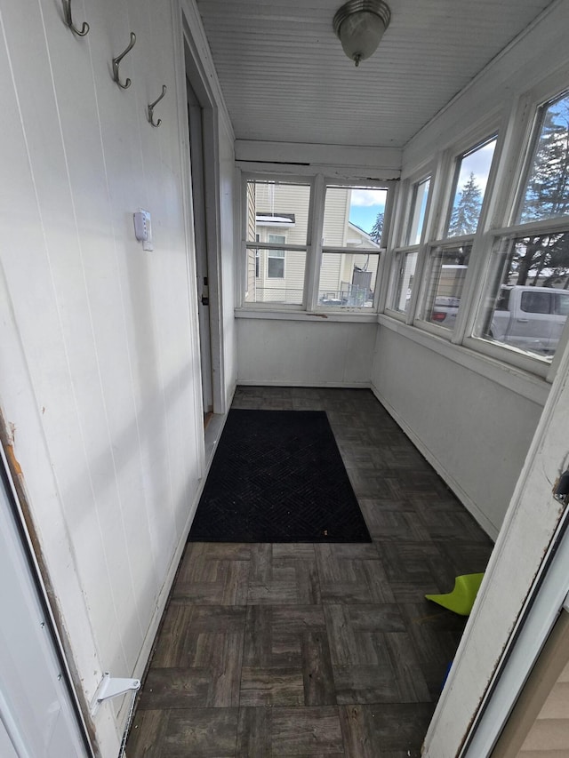 hall featuring dark parquet flooring