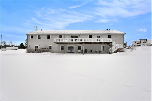 view of snow covered rear of property