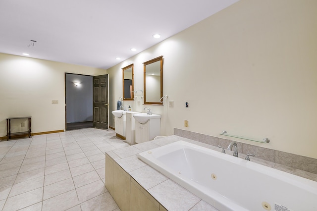 bathroom featuring tile patterned flooring, vanity, and tiled tub