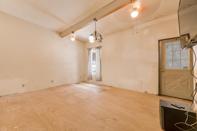 spare room with ceiling fan with notable chandelier and beam ceiling