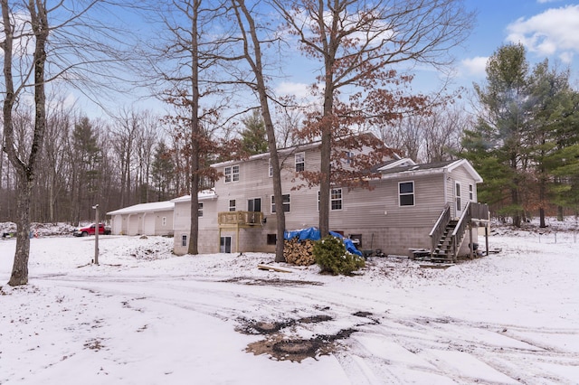 view of snow covered back of property