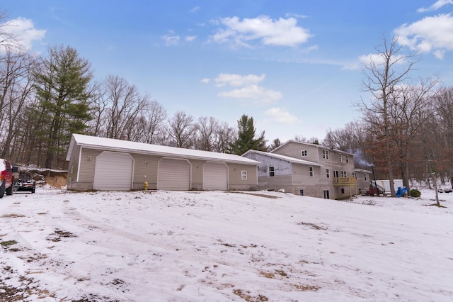 view of snow covered rear of property