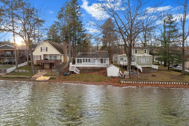 rear view of property with a deck with water view