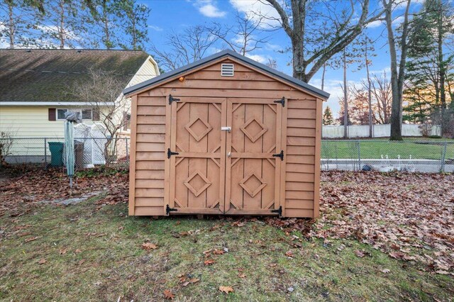 view of shed with fence