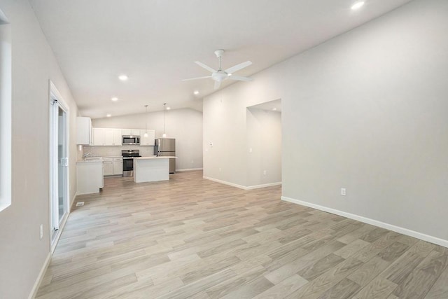 unfurnished living room with ceiling fan, light wood-type flooring, and lofted ceiling